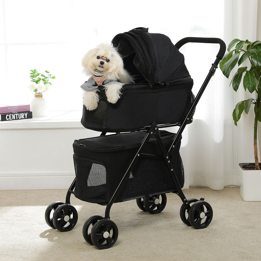 Black pet stroller with a small white dog inside, indoors.