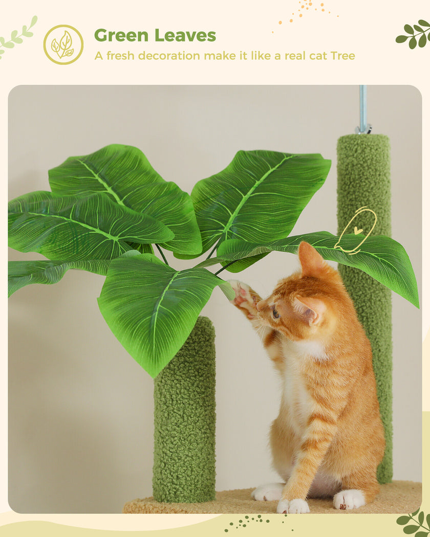 Cat playing with a green leafy cat tree decoration