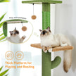 Cat tree with a cat sitting on a platform, surrounded by greenery.