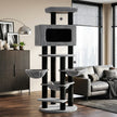 Black and grey extra tall cat tree with three hammocks and a large enclosed condo in a modern living room