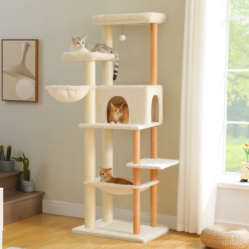 Cat tree with multiple levels and cats on a light-colored wall and wooden floor.