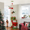 Festive red and green floor-to-ceiling cat tree with two private condos, sisal posts, platforms, and cats near a Christmas tree