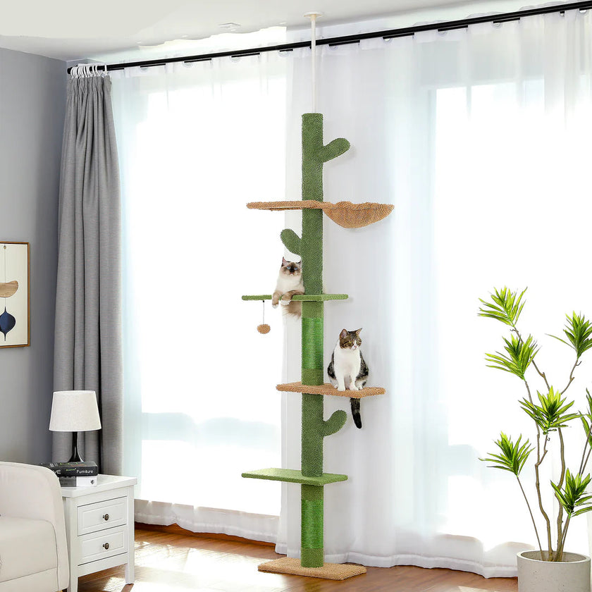 Cat tree with multiple levels in a room with curtains and a plant