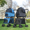 Two pet strollers, one blue and one black, on a grassy area with trees and buildings in the background.