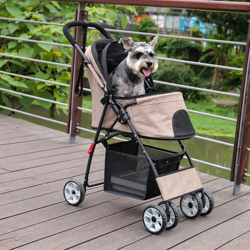 Dog in a pet stroller on a wooden deck with a view of water and greenery.