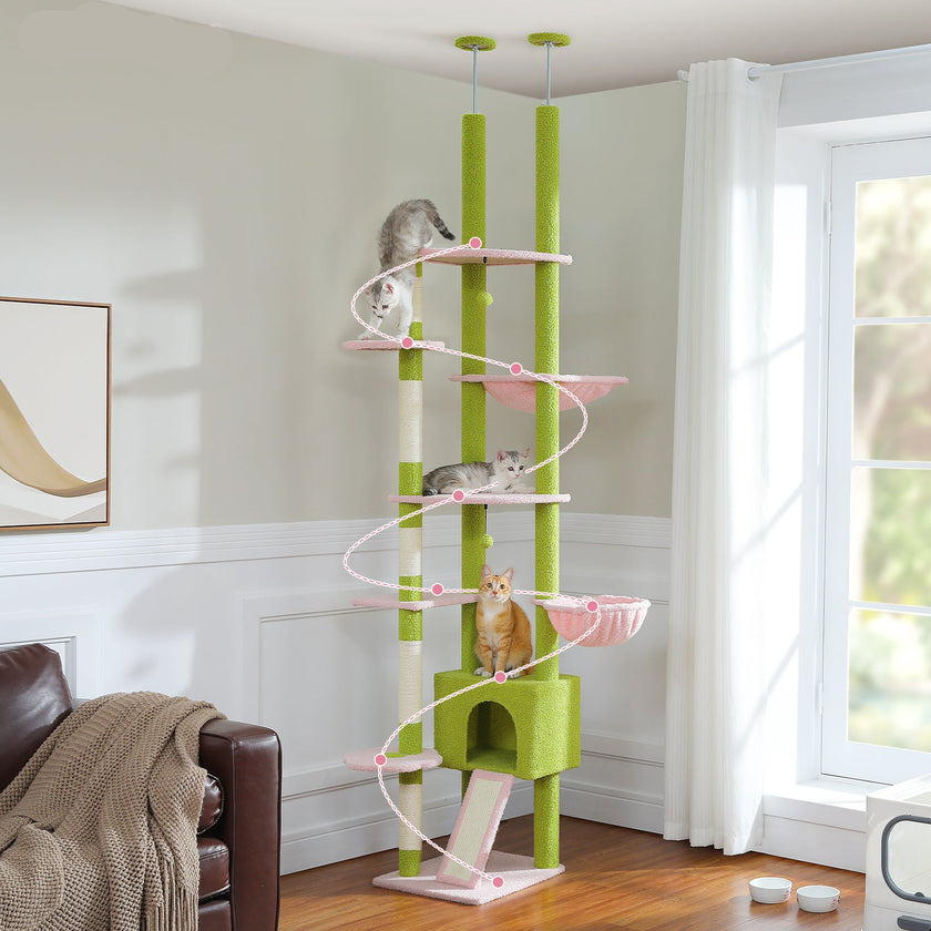 Green and white cat tree with multiple levels in a room with a window and furniture.