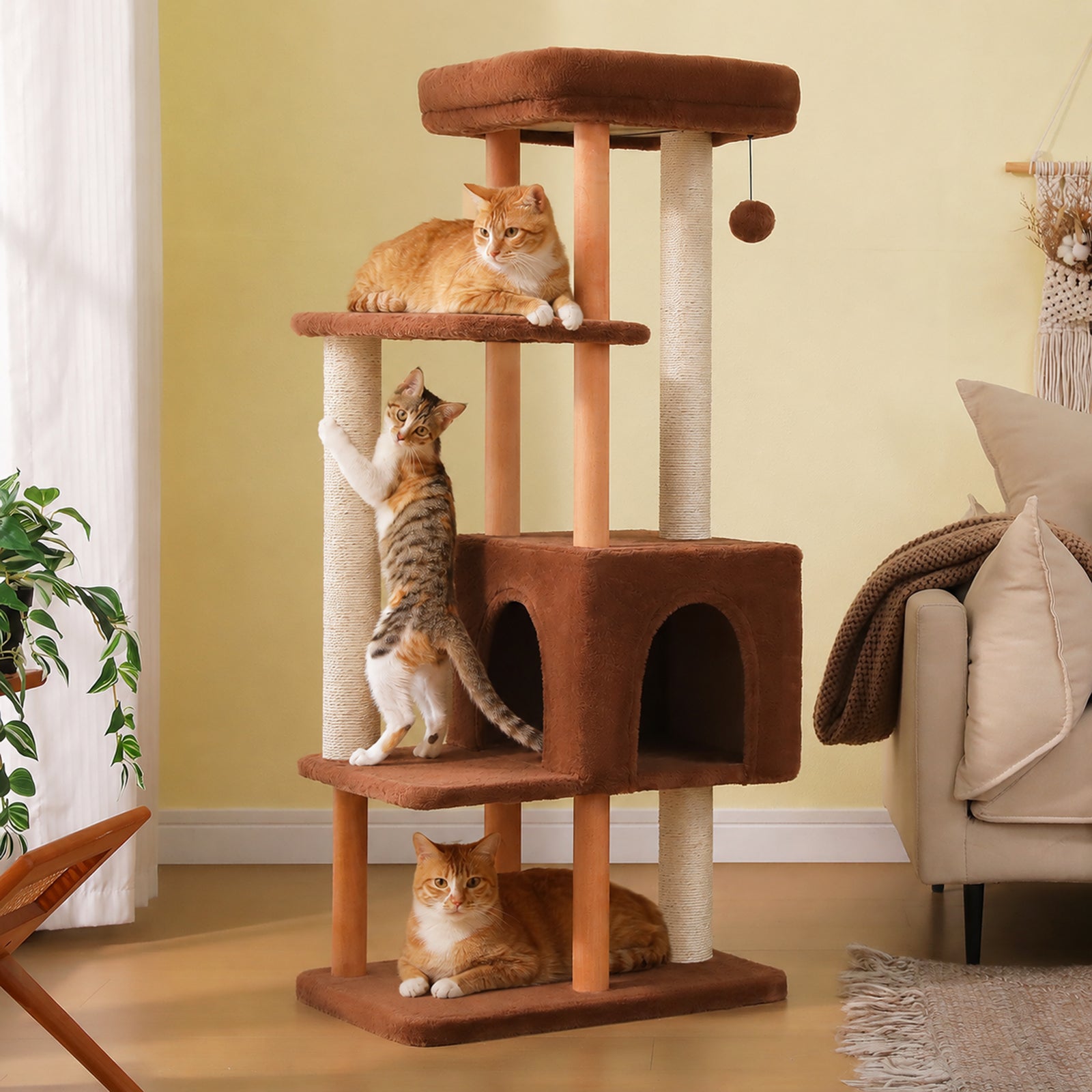 135 cm wooden cat tree with spacious condo, padded top perch, natural wood posts, sisal scratching posts, and cats in a living room