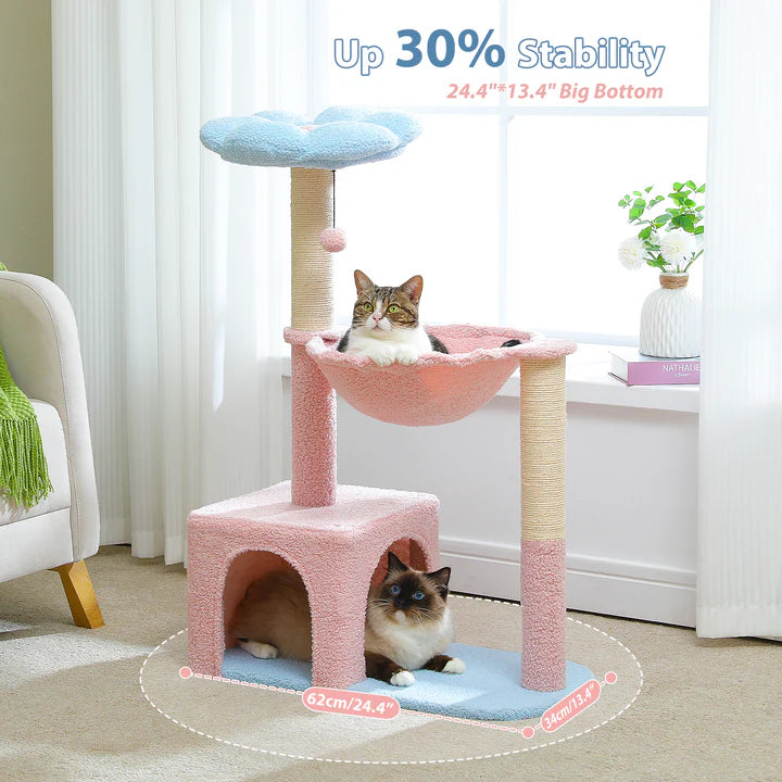 Pink and beige cat tree with two cats inside, in a room setting.