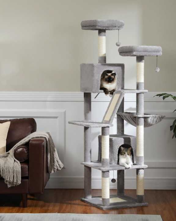 Cat tree with multiple levels and a cat sitting on one of the platforms in a living room.
