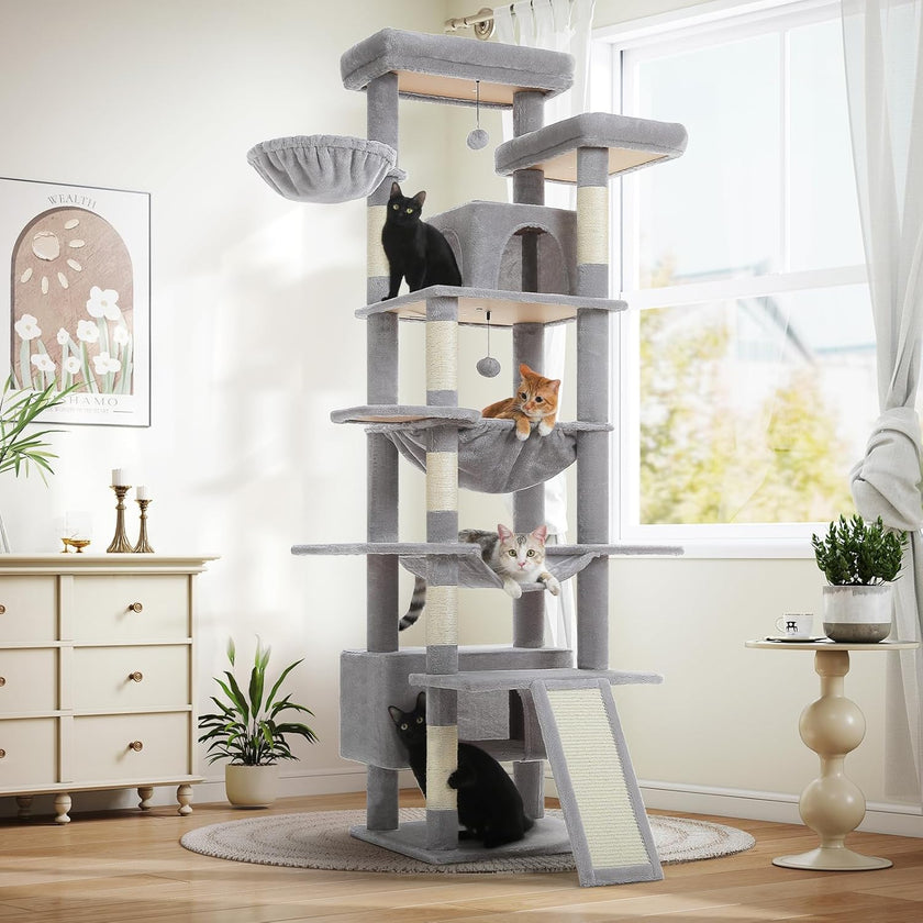 Cat tree with multiple cats in a room with a window and furniture.