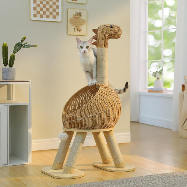 Cat sitting on a dinosaur-shaped wicker cat tree in a room with a window and plants.