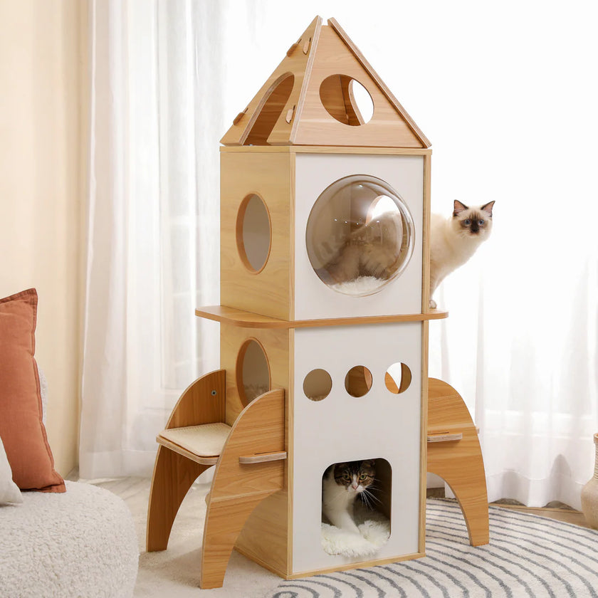 Wooden cat play tower with multiple levels and a round window, featuring two cats inside.