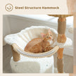 Cat sitting in a white cat hammock attached to a solid wood post of a luxury cat tree