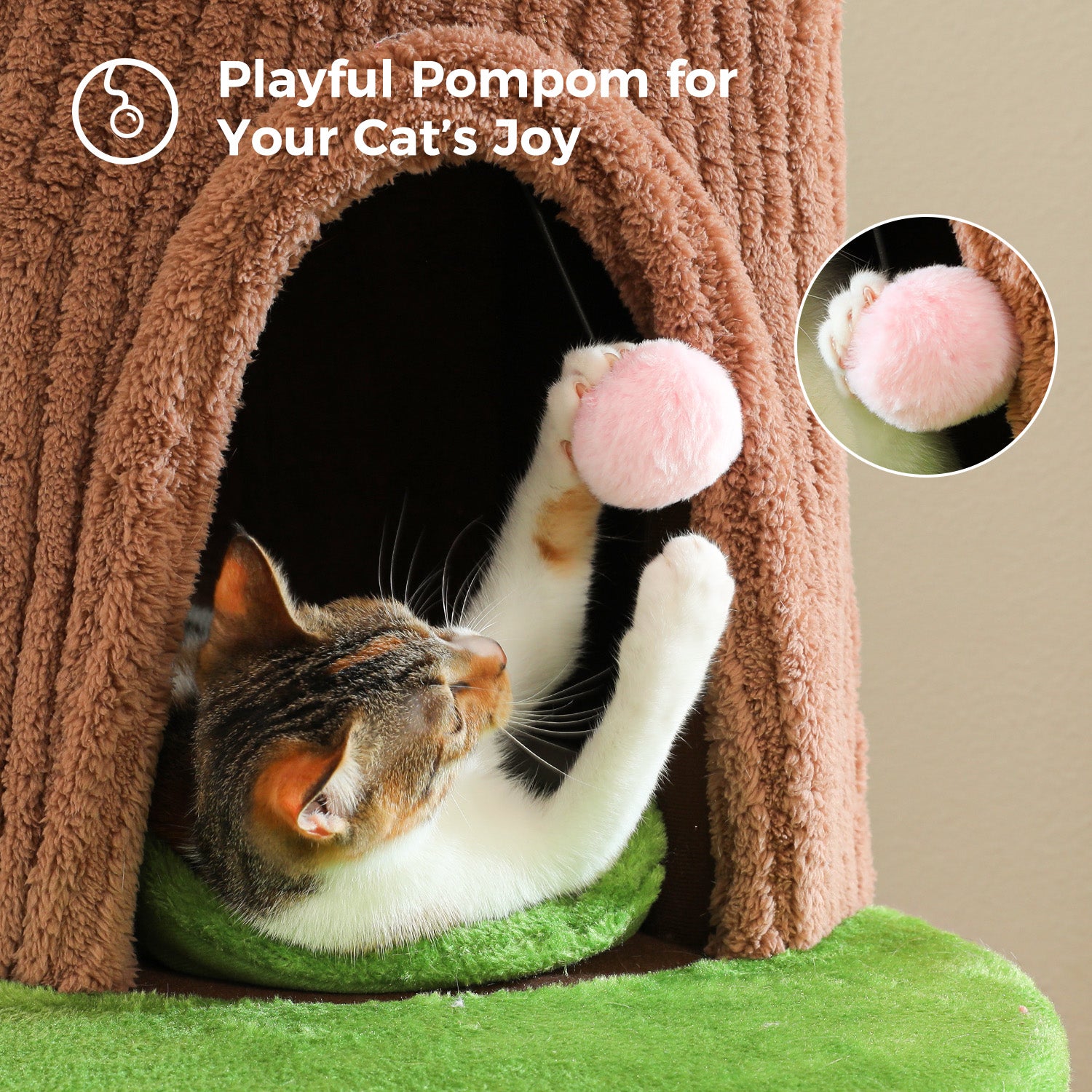 Cat playing with a pink hanging pom-pom toy inside a brown plush condo on a flower cat tree