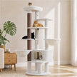 White 188 cm tall cat tree with two hammocks, large condo, padded top perch, and sisal scratching post in a bright living room