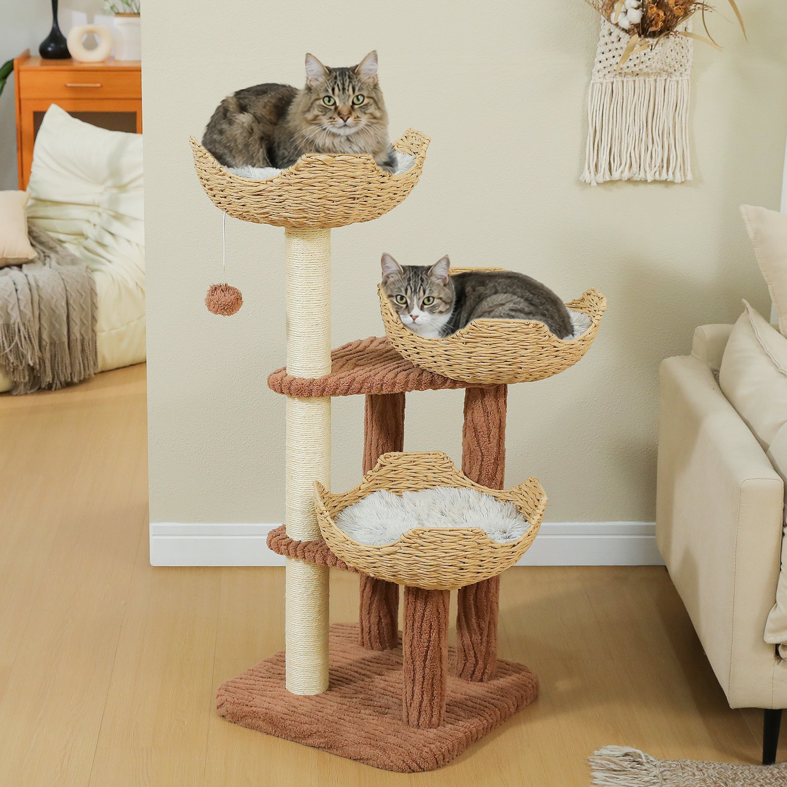 Two cats resting on a white rattan cat tree with three elevated basket beds and natural sisal posts